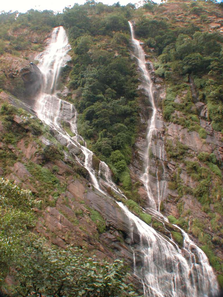 Manaslu 03 02 Waterfalls I walked along the narrow trail making ups and downs and arrived at Khorlabesi (970m) at 10:00. A young bearded Maoist, dressed in a t-shirt and army fatigues, talked to me. I showed him my 'tax form', and he was satisfied. A second Maoist young man obtained tax from another traveler. Just after arriving on the eastern side of the Buri Gandaki, there was a two-streamed waterfall dropping from the heavens.